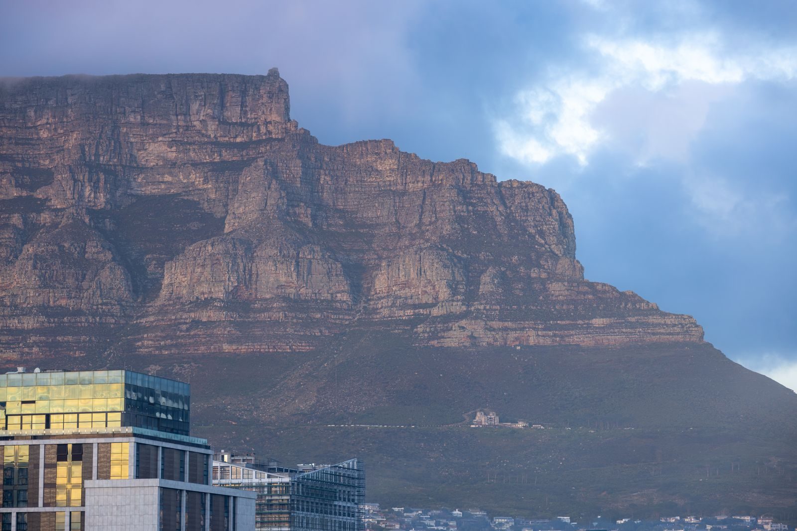 Table Mountain rising above Cape Town under a moody evening sky
